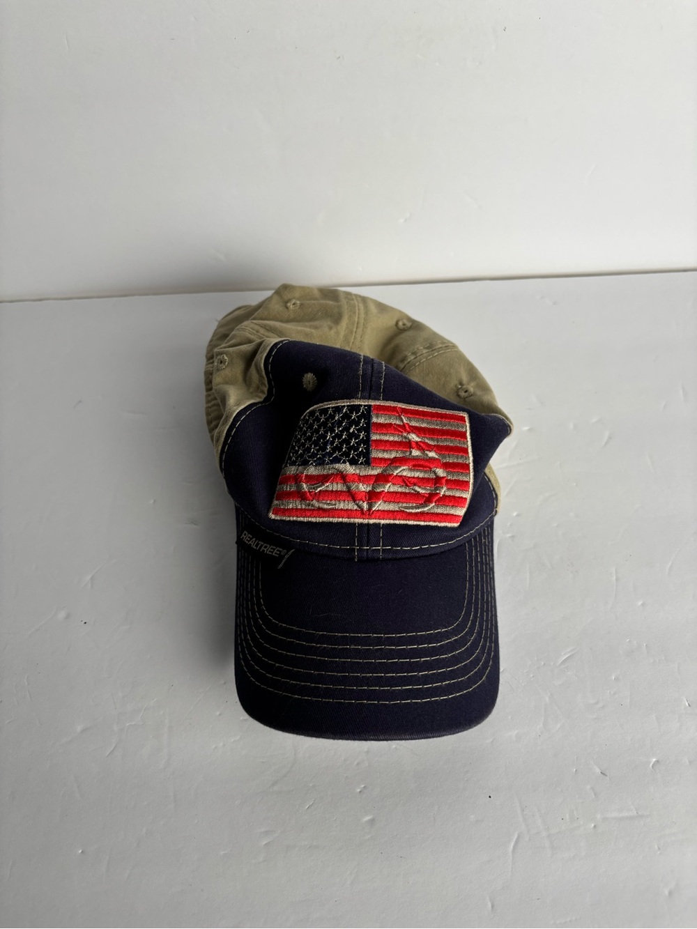Realtree navy & khaki baseball cap with American flag patch.